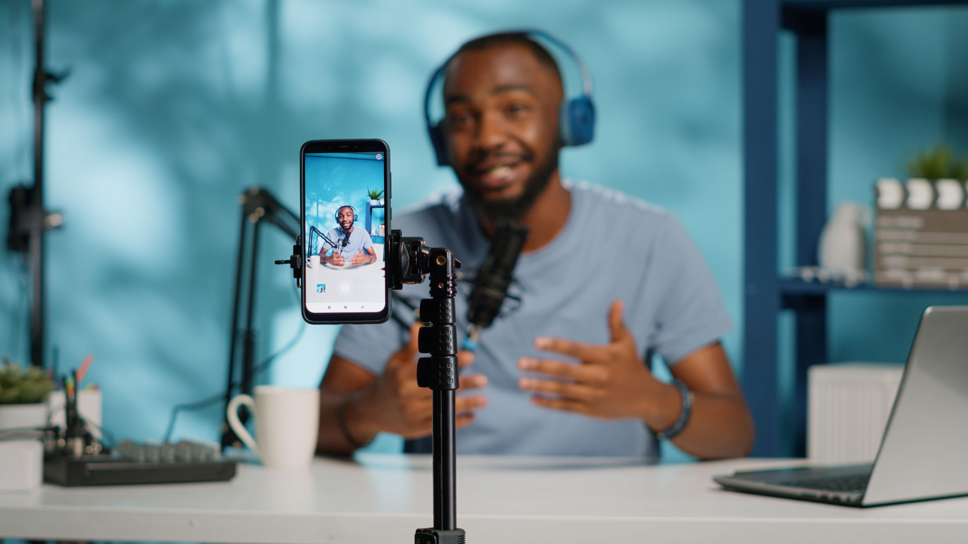 A creator recording a video on a phone in a home studio